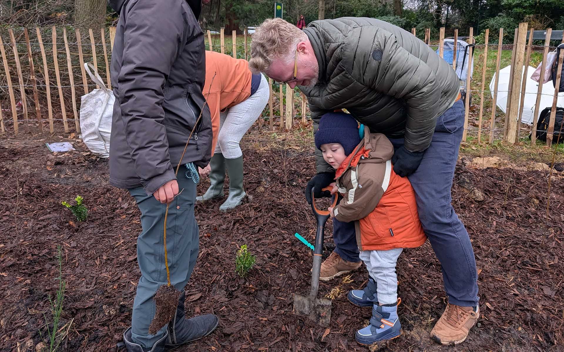 Hanger Hill Park Tiny Forest child planting a tree