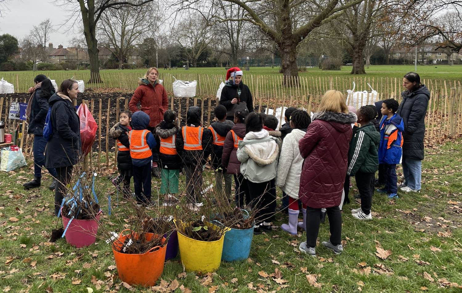 Wormholt Park Tiny Forest: Earthwatch demonstrating planting trees